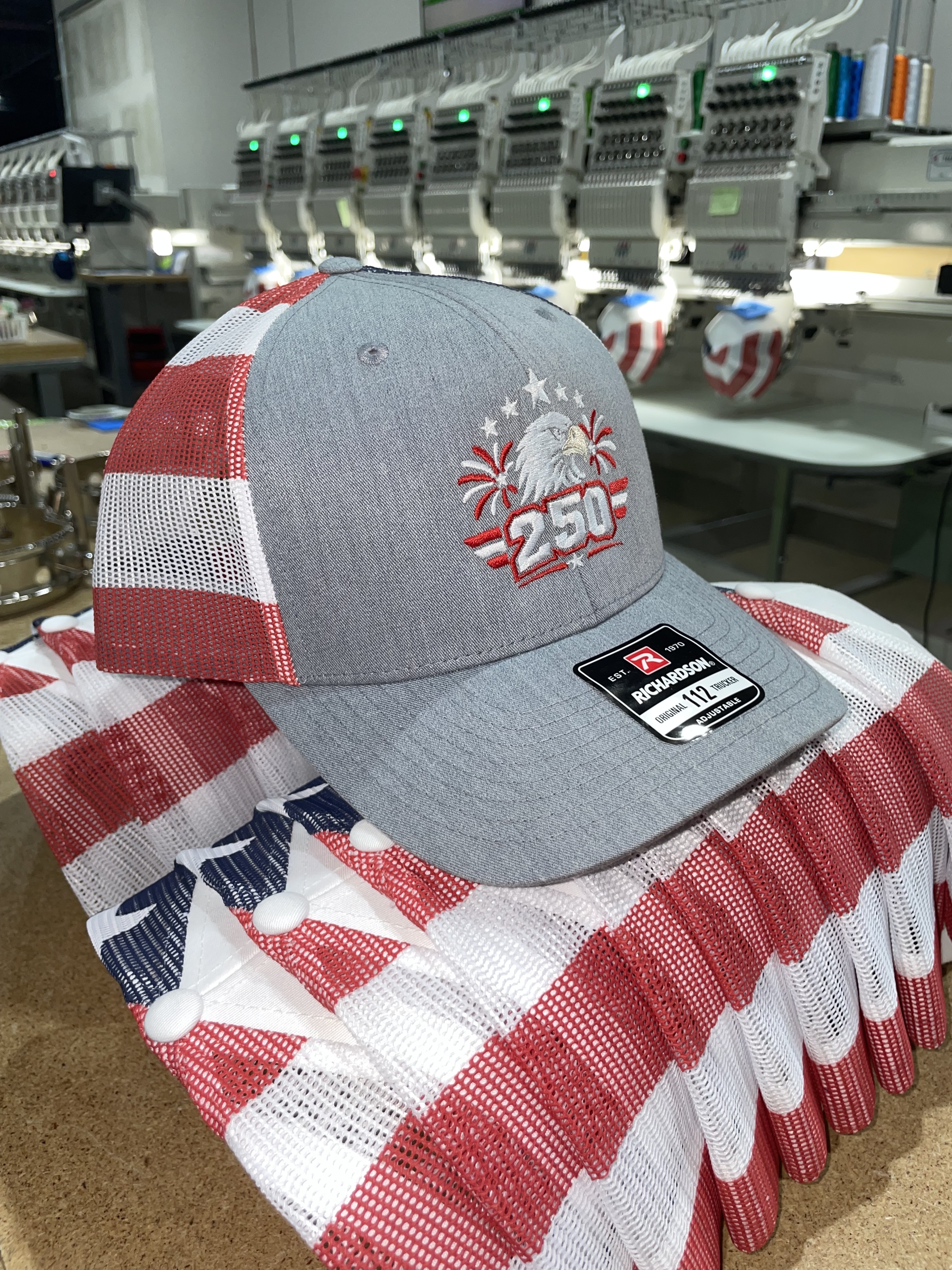 Custom 250 eagle hat on an American flag at the HatLaunch embroidery floor